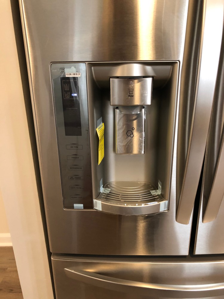 Stainless steel refrigerator with in-door water and ice dispenser.