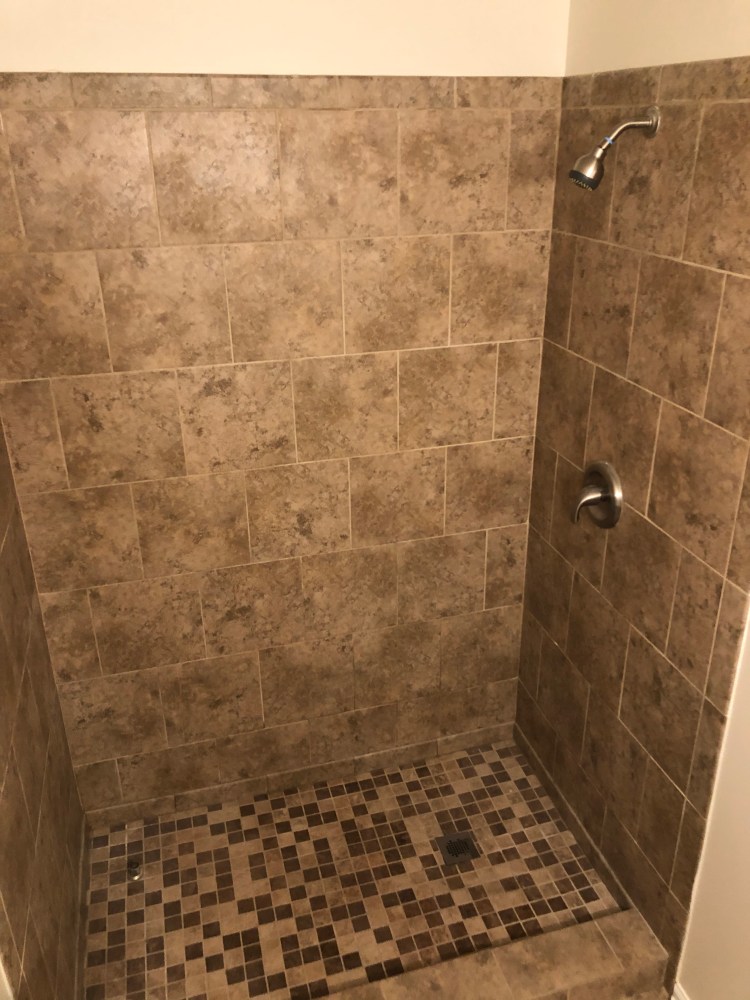 The shower in the second bedroom's private bath is customized for tall bathers!