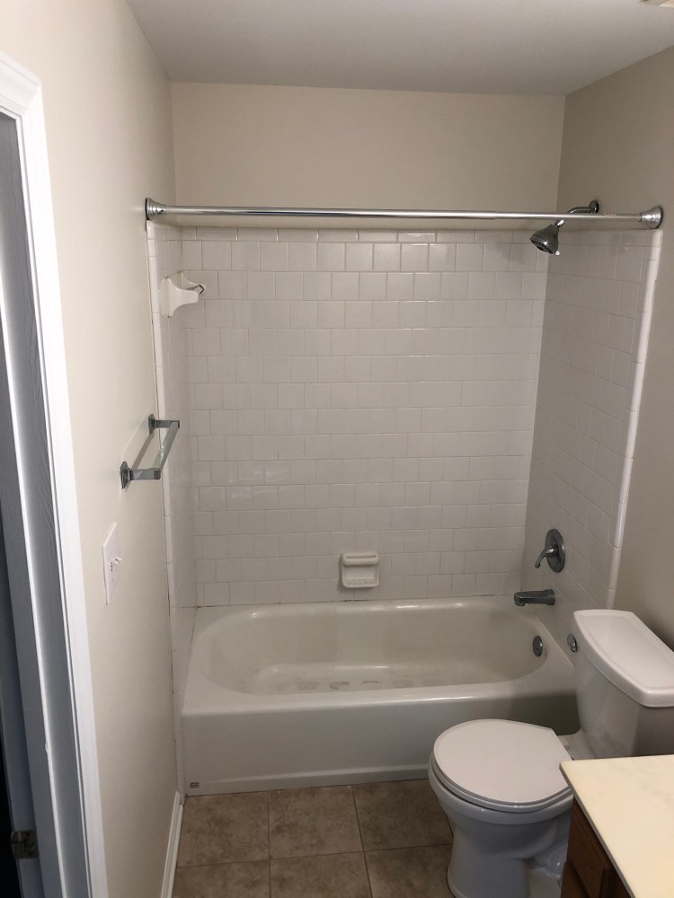 Main level full bath attached to the first bedroom.