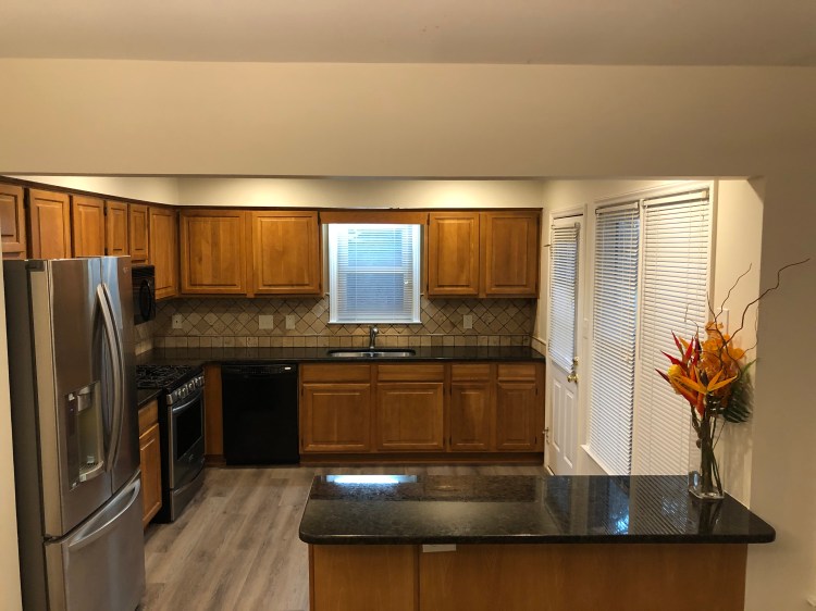 Granite countertops and tumbled marble backsplash in the kitchen,