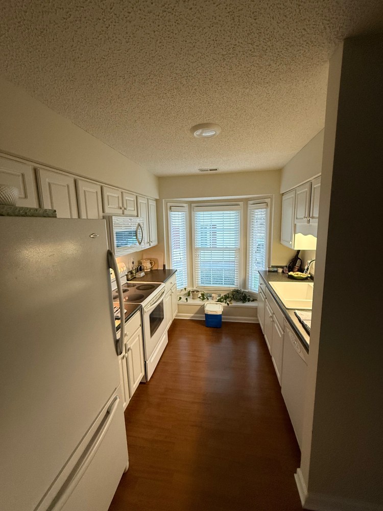 Galley kitchen with bay window.